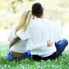 Loving couple sitting and hugging in the park.