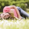 It's not about him, it's about you. A beautiful woman is lying on the grass.